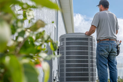 Residential HVAC service technician working on home air conditioning system